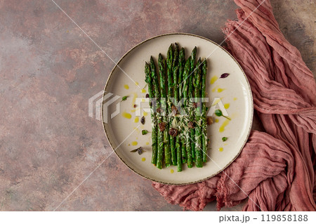 grilled asparagus , spices and herbs, parmesan cheese, on a beige plate, top view, rustic, no people grilled asparagus , spices and herbs, parmesan cheese, on a beige plate, top view, rustic, no people 119858188