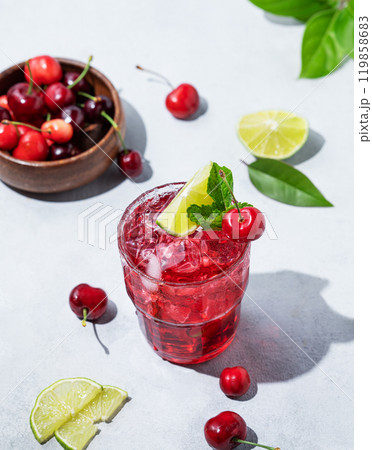 Cherry-lime mojito cocktail with mint, lime and ice on a light background with fresh berries 119858683