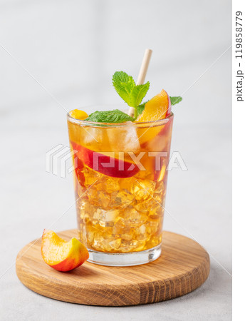 Refreshing peach iced mint tea. The concept of a healthy homemade cold summer drink Refreshing peach iced mint tea. The concept of a healthy homemade cold summer drink 119858779