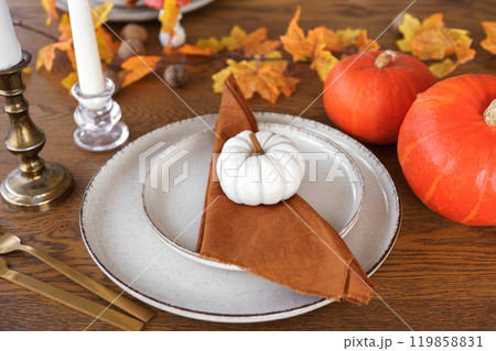Autumn, fall, Halloween or Thanksgiving day table setting. Plates with yellow leaves and pumpkins 119858831