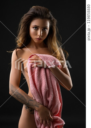 Slim nude girl wrapped in pink towel shot 119858880