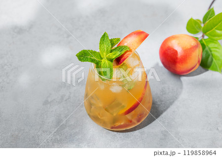 Refreshing peach cocktail, lemonade or iced tea on a blue background with summer shadows. Refreshing peach cocktail, lemonade or iced tea on a blue background with summer shadows. 119858964