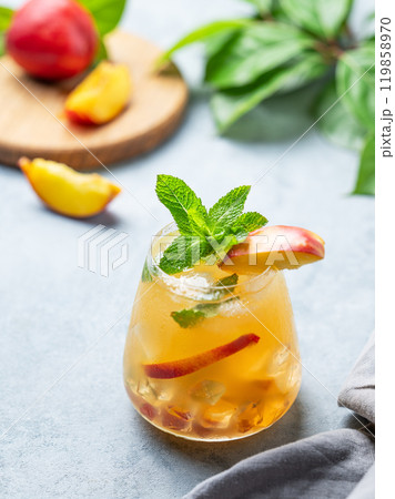 Refreshing peach cocktail, lemonade or iced tea on a light background. 119858970