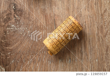 Close-up of used wine cork on wooden background Close-up of used wine cork on wooden background 119859157