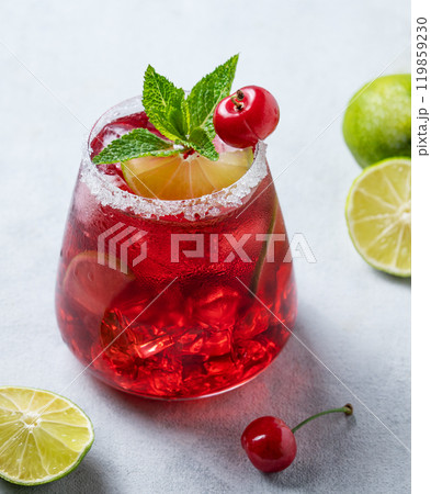 Cherry-lime mojito cocktail with mint, lime and ice on a light background with fresh berries Cherry-lime mojito cocktail with mint, lime and ice on a light background with fresh berries 119859230
