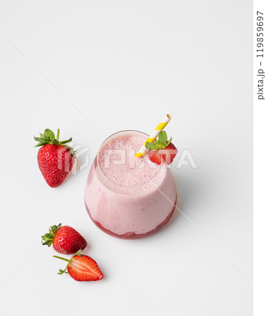 A strawberry milkshake or smoothie in a glass with strawberries on a white background A strawberry milkshake or smoothie in a glass with strawberries on a white background 119859697