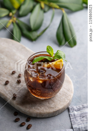 Coffee espresso with tonic in a glass with mint, ice and lemon on a marble board Coffee espresso with tonic in a glass with mint, ice and lemon on a marble board 119860025