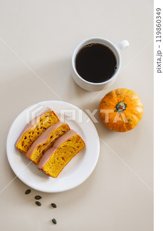 Slices of pumpkin sweet bread or cake with icing on a plate on a light background Slices of pumpkin sweet bread or cake with icing on a plate on a light background 119860349