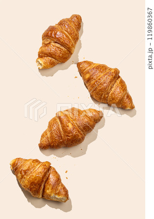Flat lay of fresh croissants on yellow background with shadow. Flat lay of fresh croissants on yellow background with shadow. 119860367