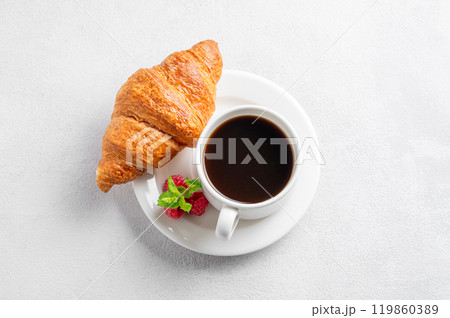 Cup of espresso coffee and croissant with fresh raspberries on a plate Cup of espresso coffee and croissant with fresh raspberries on a plate 119860389
