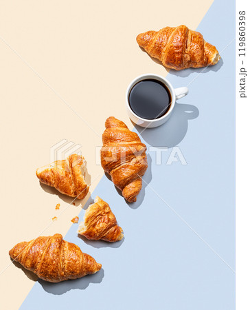 Flat lay of espresso coffee cup and fresh croissants on yellow and blue background with shadow. Flat lay of espresso coffee cup and fresh croissants on yellow and blue background with shadow. 119860398