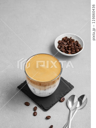 Iced dalgona coffee. Whipped instant coffee in a glass with ice on a slate board  119860436
