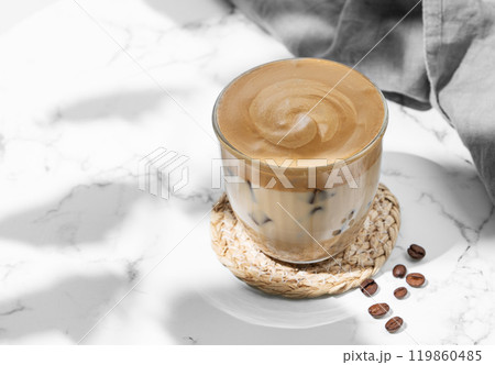 Iced dalgona coffee. Whipped instant coffee in a glass with ice on a marble background 119860485