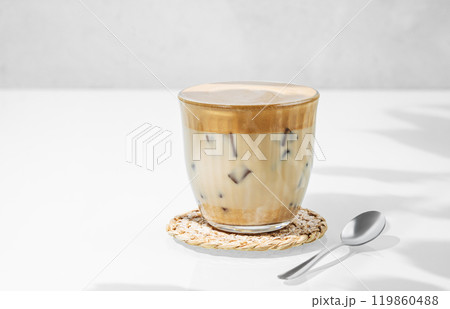 Dalgona coffee. Whipped instant coffee in a glass with ice on a white background Dalgona coffee. Whipped instant coffee in a glass with ice on a white background 119860488