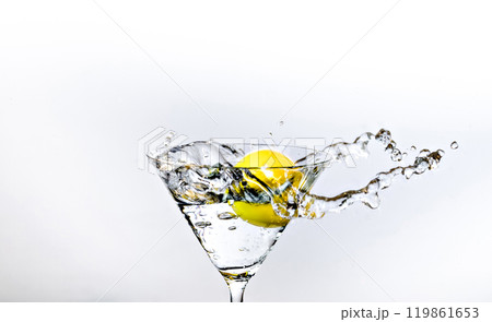 Close up of water drop falling into a glass on white background	 119861653