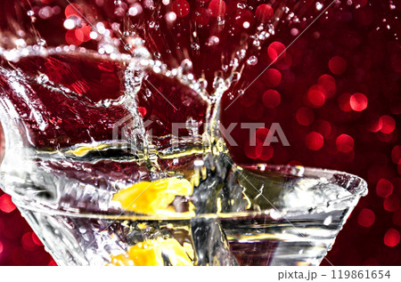 Close up of water drop falling into a glass on white background Close up of water drop falling into a glass on white background 119861654