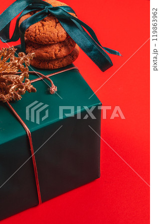 Gift box with decoration and baked goods on a red background 119863962