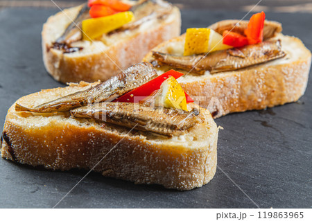 three fish sandwiches on a stone board on the table. selective focus 119863965