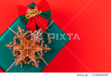 A gift box with a star decoration and the inscription Merry Christmas A gift box with a star decoration and the inscription Merry Christmas 119864006