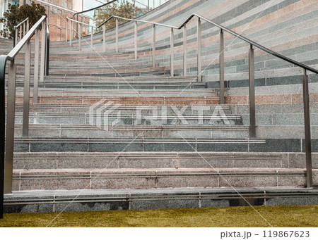 Perspective view of outdoor steps different coloured with stainless steel sleek railings handle grip. Perspective view of outdoor steps different coloured with stainless steel sleek railings handle grip. 119867623