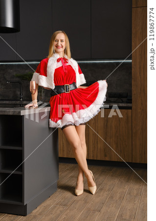 Happy woamn in Snow Maiden costume leaning on kitchen table Happy woamn in Snow Maiden costume leaning on kitchen table 119867774