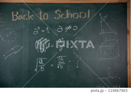 A chalkboard with math problems and the words back to school written on it. The chalkboard is green and has a clock on the left side A chalkboard with math problems and the words back to school written on it. The chalkboard is green and has a clock on the left side 119867865