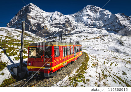 Electric tourist cogwheel train on the snowy slope in Switzerland Electric tourist cogwheel train on the snowy slope in Switzerland 119868916