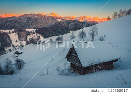 Winter scenery with snowy hut on the hill at sunset 119868917
