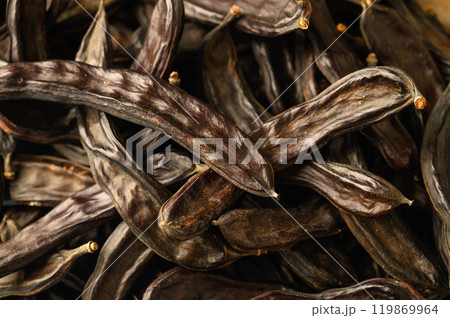 Carob pods in a pile as a background Carob pods in a pile as a background 119869964