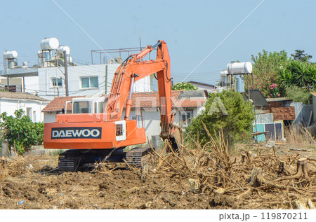 Gazeveren Cyprus 03.07.2024 - excavator uproots the roots of orange trees 119870211