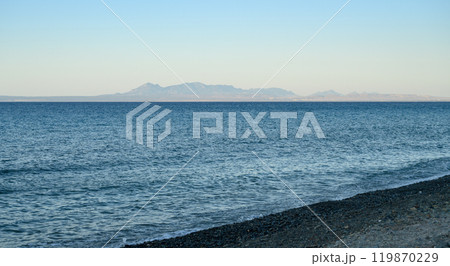 Image shows a deserted beach at sunset 119870229