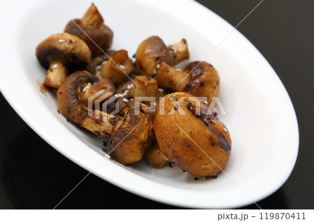 Fried champignons on a white oval plate. Fried champignons on a white oval plate. 119870411