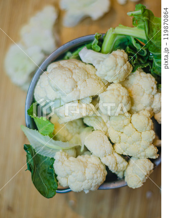 Raw and fresh cauliflower in pot on the table of the kitchen to be cooked. High quality photo Raw and fresh cauliflower in pot on the table of the kitchen to be cooked. High quality photo 119870864