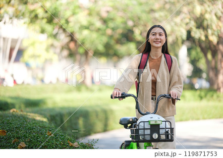 A woman is riding a bicycle with a basket on the front 119871753