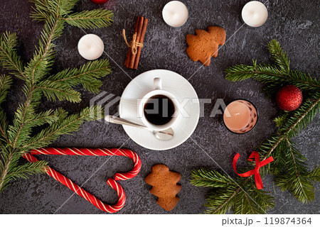 Christmas brown background with fir tree and decoration on dark wooden board. Christmas wallpaper. Christmas, New Year's composition with copy space for text. Flat lay, top view Christmas brown background with fir tree and decoration on dark wooden board. Christmas wallpaper. Christmas, New Year's composition with copy space for text. Flat lay, top view 119874364