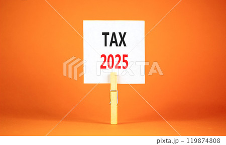 Planning tax 2025 new year symbol. Concept words Tax 2025 on beautiful white paper on wooden clothespin. Beautiful orange background. Business tax 2025 new year concept. Copy space. 119874808