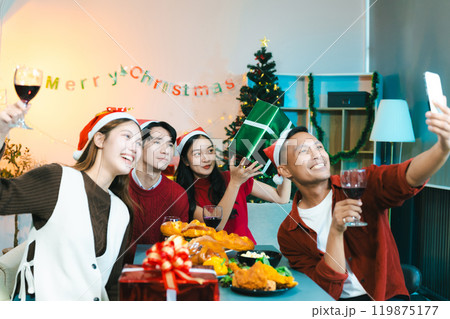 Dinner and group of people celebrating together at Merry Christmas and Happy New Year. 119875177