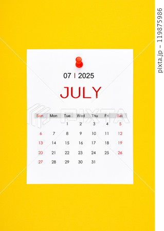 July 2025 calendar page with push pin on yellow background. July 2025 calendar page with push pin on yellow background. 119875986