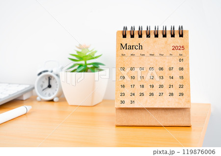 March 2025 desk calendar on worktable. 119876006