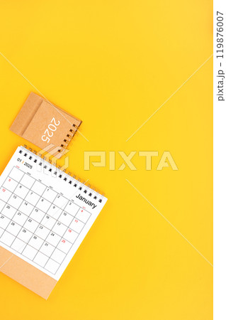 2025 January Desk Calendar On Yellow Background, Position with copy space On Yellow Background. 119876007