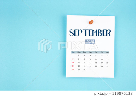 September 2025 calendar page with push pin on blue background. September 2025 calendar page with push pin on blue background. 119876138