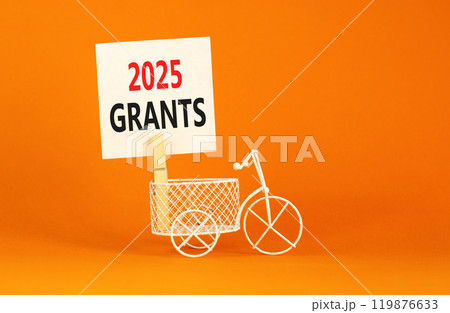 Planning 2025 grants new year symbol. Concept words 2025 Grants on beautiful white paper on wooden clothespin. Bicycle. Beautiful orange background. Business 2025 grants new year concept. Copy space. Planning 2025 grants new year symbol. Concept words 2025 Grants on beautiful white paper on wooden clothespin. Bicycle. Beautiful orange background. Business 2025 grants new year concept. Copy space. 119876633
