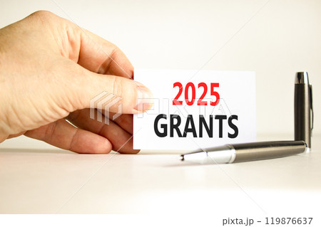 Planning 2025 grants new year symbol. Concept words 2025 Grants on beautiful white card. Beautiful white background. Businessman hand. Business 2025 grants new year concept. Copy space. 119876637