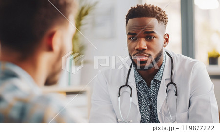 A young male handsome African American doctor in a white coat is talking with a patient in a modern office of a hospital, private clinic Public Health This is AI-generated item 119877222