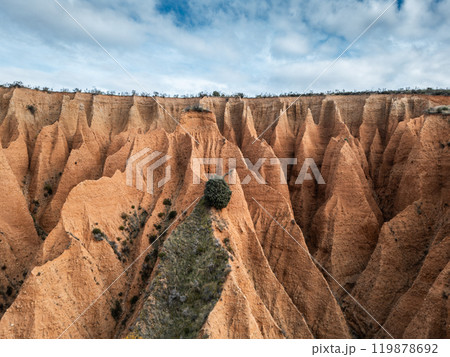 red sand and clay mountains Las Carcavas by Madrid, eroded badlands formation and desert landscape, aerial top view red sand and clay mountains Las Carcavas by Madrid, eroded badlands formation and desert landscape, aerial top view 119878692