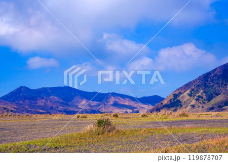Landscape of rolling hills with vibrant green grass under a blue sky Landscape of rolling hills with vibrant green grass under a blue sky 119878707