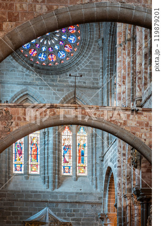 stained glass windows illuminate historic church interior in Avila cathedral, vibrant colors and intricate designs,peaceful atmosphere during mid-morning sunlight 119879201