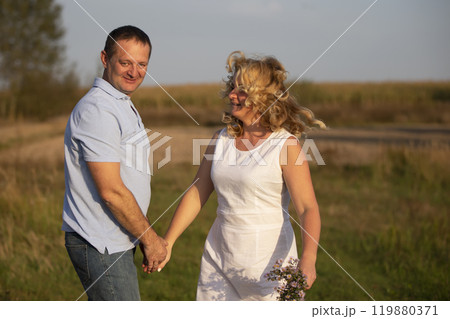 Beautiful middle-aged couple in love on the background of nature. 119880371