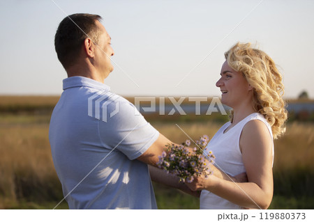Beautiful middle-aged couple in love on the background of nature. Husband and wife. Beautiful middle-aged couple in love on the background of nature. Husband and wife. 119880373
