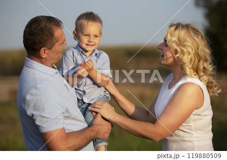 Happy mom dad and little son in nature. Family. Happy mom dad and little son in nature. Family. 119880509